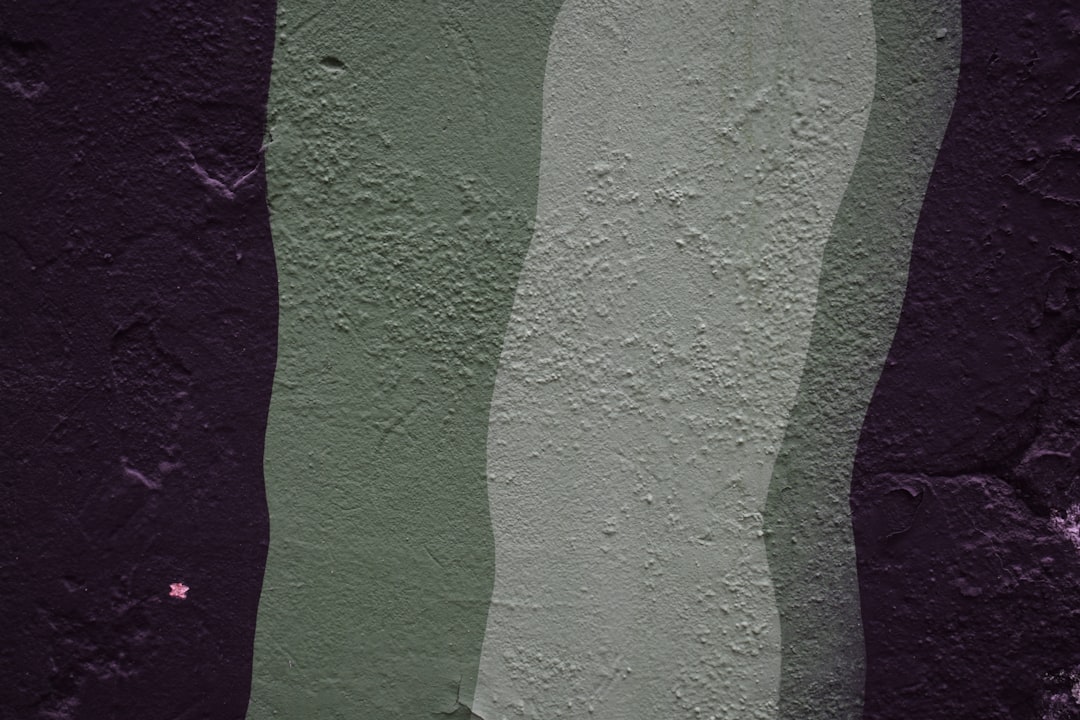 a purple and green painting on a wall