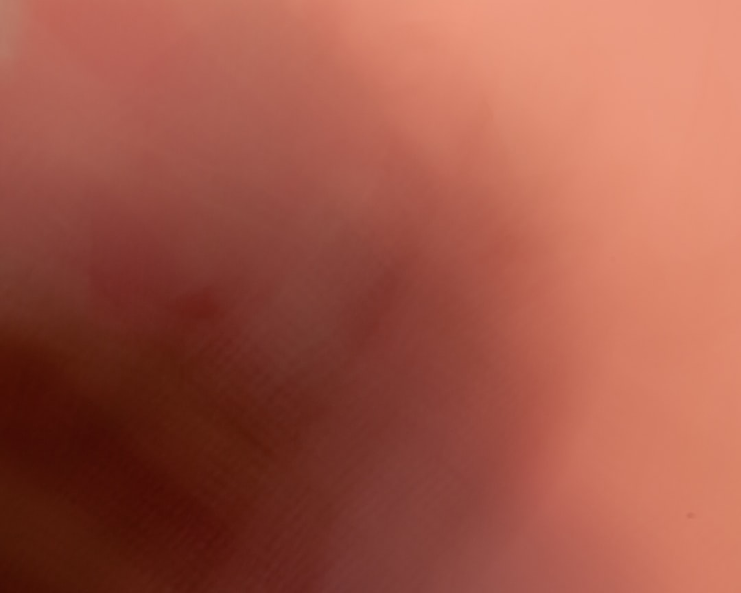 A blurry photo of a red and white bird