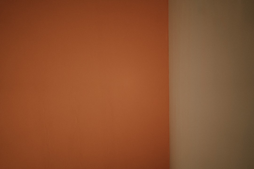 a white toilet sitting in a bathroom next to a wall